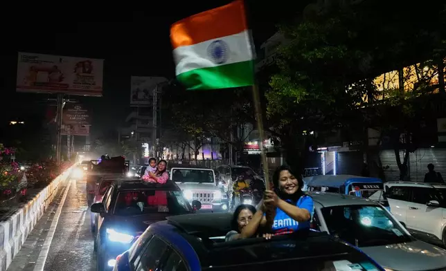 Cricket fans celebrate India's win in the T20 World Cup cricket final match against New Zealand, in Guwahati, India, Sunday, March 8, 2026. (AP Photo/Anupam Nath)