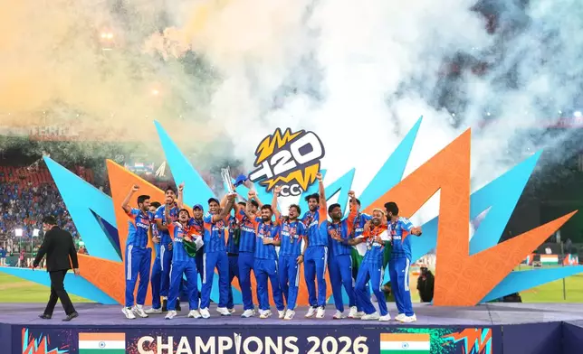 India's players celebrate with the trophy after winning the T20 World Cup final match against New Zealand in Ahmedabad, India, Sunday, March 8, 2026. (AP Photo/Ajit Solanki)