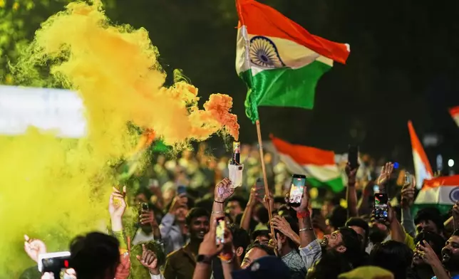 Cricket fans celebrate after India defeated New Zealand final match of T20 World Cup in Lucknow Uttar Pradesh state, India, Sunday, March 8, 2026. (AP Photo/Rajesh Kumar Singh)