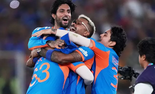 India's players celebrate after winning the T20 World Cup cricket final match against New Zealand in Ahmedabad, India, Sunday, March 8, 2026. (AP Photo/Ajit Solanki)
