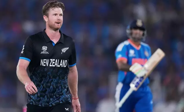 New Zealand's James Neesham celebrates the wicket of India's captain Suryakumar Yadav, right, during the T20 World Cup cricket final match between India and New Zealand in Ahmedabad, India, Sunday, March 8, 2026. (AP Photo/Ajit Solanki)