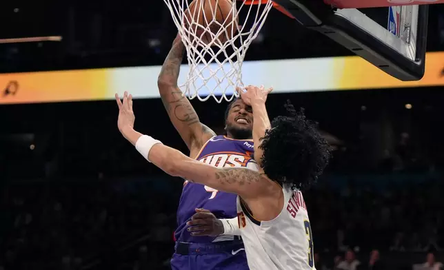 Denver Nuggets guard Julian Strawther (3) fouls Phoenix Suns guard Jalen Green during the first half of an NBA basketball game, Tuesday, March 24, 2026, in Phoenix. (AP Photo/Rick Scuteri)
