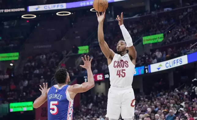 Cleveland Cavaliers guard Donovan Mitchell (45) shoots over Philadelphia 76ers guard Quentin Grimes (5) in the first half of an NBA basketball game in Cleveland, Monday, March 9, 2026. (AP Photo/Sue Ogrocki)