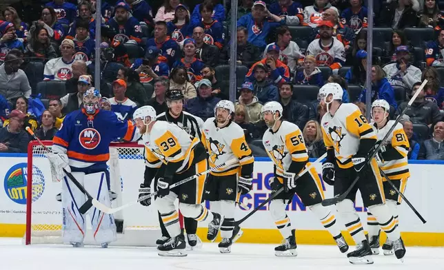 New York Islanders goaltender Ilya Sorokin (30), watches as Pittsburgh Penguins' Anthony Mantha (39) skates past him with teammates after Mantha scored a goal during the second period of an NHL hockey game Monday, March 30, 2026, in Elmont, N.Y. (AP Photo/Frank Franklin II)