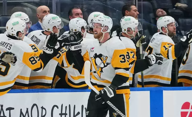 Pittsburgh Penguins' Anthony Mantha (39) celebrates with teammates after scoring a goal during the second period of an NHL hockey game against the New York Islanders Monday, March 30, 2026, in Elmont, N.Y. (AP Photo/Frank Franklin II)