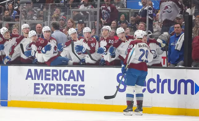 Colorado Avalanche center Nathan MacKinnon celebrates with the bench after scoring during the first period of an NHL hockey game against the Los Angeles Kings Monday, March. 2, 2026 in Los Angeles. (AP Photo/Ryan Sun)