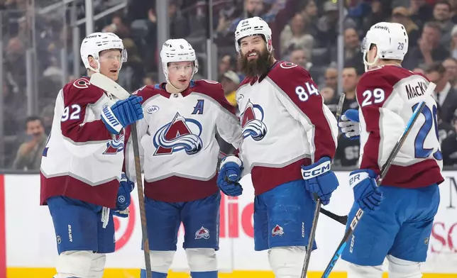 Colorado Avalanche left wing Gabriel Landeskog, left, celebrate with defenseman Cale Makar, defenseman Brent Burns, and center Nathan MacKinnon after scoring during the first period of an NHL hockey game against the Los Angeles Kings Monday, March, 2, 2026 in Los Angeles. (AP Photo/Ryan Sun)