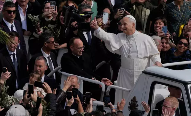Pope Leo XIV leaves after presiding over Mass in St. Peter's Square at the Vatican on the Catholic feast of Palm Sunday, commemorating Jesus' arrival in Jerusalem, Sunday, March 29, 2026. (AP Photo/Alessandra Tarantino)