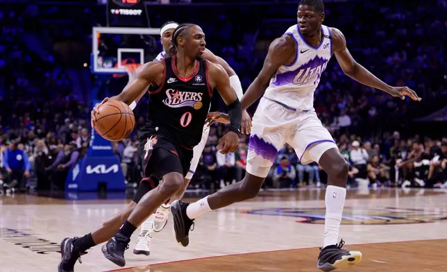 Philadelphia 76ers' Tyrese Maxey, left, drives to the basket against Utah Jazz's Mo Bamba, right, during the first half of an NBA basketball game, Wednesday, March 4, 2026, in Philadelphia. (AP Photo/Chris Szagola)