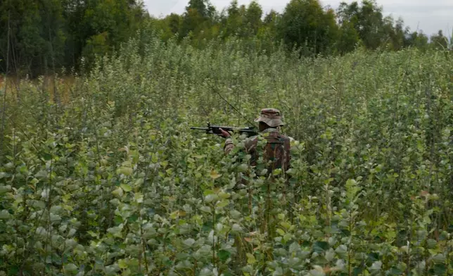 A South African National Defense Force soldier patrols in a dense bush where illegal miners are operating, in Randfontein, in Johannesburg, South Africa, Thursday, March 12, 2026. (AP Photo/Themba Hadebe)