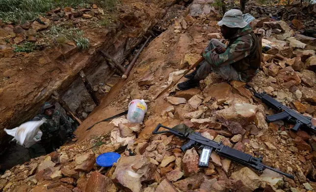 South African National Defense Force soldiers retrieve clothing and food stock left by illegal miners, in Randfontein, in Johannesburg, South Africa, Thursday, March 12, 2026. (AP Photo/Themba Hadebe)