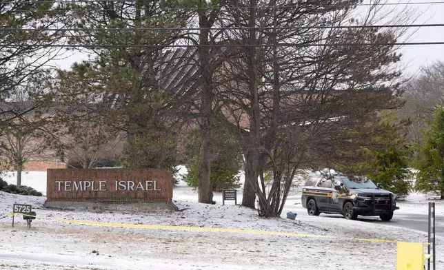 A police vehicle sits outside the Temple Israel synagogue Friday, March 13, 2026, in West Bloomfield Township, Mich. (AP Photo/Paul Sancya)