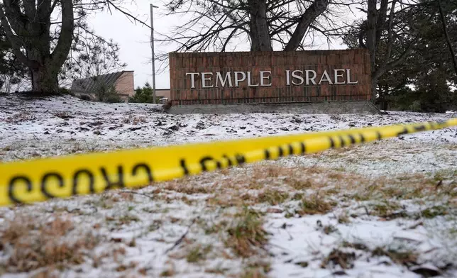 Police tape hangs outside the Temple Israel synagogue Friday, March 13, 2026, in West Bloomfield Township, Mich. (AP Photo/Paul Sancya)