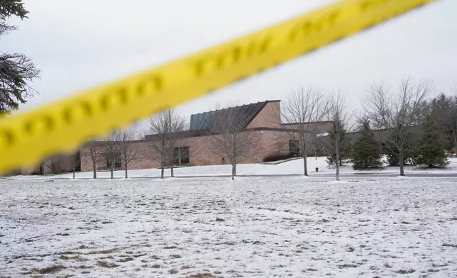 Police tape hangs outside the Temple Israel synagogue Friday, March 13, 2026, in West Bloomfield Township, Mich. (AP Photo/Paul Sancya)