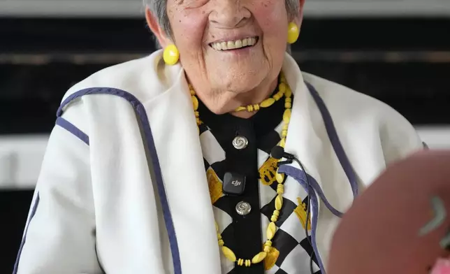 Ginette Kolinka, a 101-year-old survivor of Auschwitz, smiles after a meeting with pupils in a Paris-region high school in Saint-Maur-des-Fosses, outside Paris, France, March 21, 2026. (AP Photo/Thibault Camus)