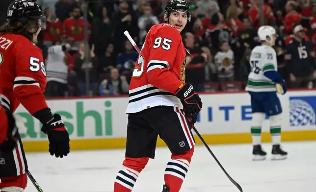 Chicago Blackhawks' Ilya Mikheyev (95) celebrates with teammates after scoring a goal during the first period of an NHL hockey game against the Vancouver Canucks in Chicago, Friday, March 6, 2026. (AP Photo/Paul Beaty)