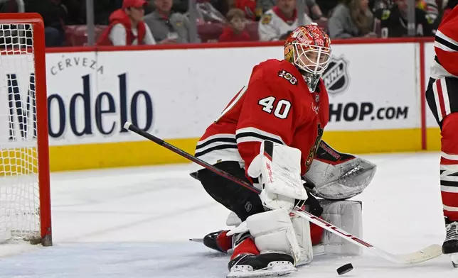 Chicago Blackhawks goalie Arvid Soderblom (40) makes a save during the second period of an NHL hockey game against the Vancouver Canucks in Chicago, Friday, March 6, 2026. (AP Photo/Paul Beaty)