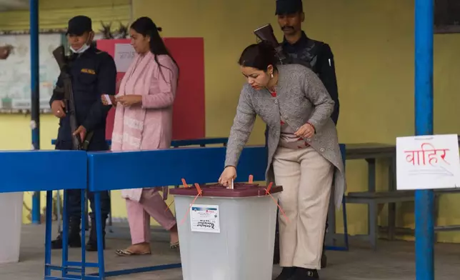 A woman casts her vote at a polling station for the parliamentary election in Kathmandu, Nepal, Thursday, March 5, 2026. (AP Photo/Niranjan Shrestha)