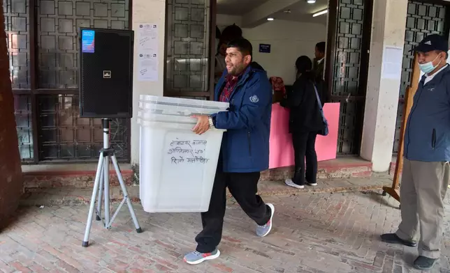 A election office staff carries ballot boxes to be loaded and transported to various polling stations a day ahead of parliamentary election in Kathmandu, Nepal, Wednesday, March 4, 2026. (AP Photo/Niranjan Shrestha)