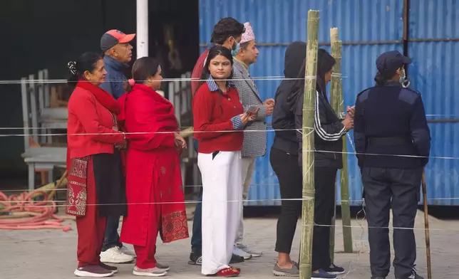 People wait in a queue to cast their votes for the parliamentary election in Kathmandu, Nepal, Thursday, March 5, 2026. (AP Photo/Niranjan Shrestha)