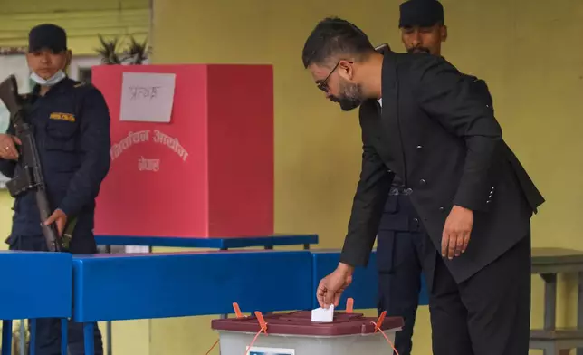 Balendra Shah, foreground, former mayor of Kathmandu Metropolitan City and prime ministerial candidate of the Rastriya Swatantra Party casts his vote at a polling station for the parliamentary election in Kathmandu, Nepal, Thursday, March 5, 2026. (AP Photo/Niranjan Shrestha)