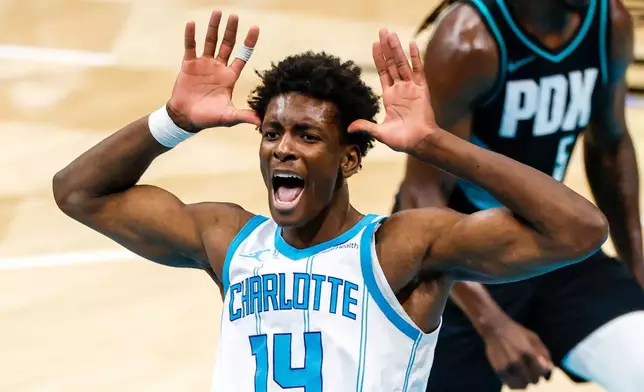 Charlotte Hornets forward Moussa Diabate celebrates after dunking against the Portland Trail Blazers during the second half of an NBA basketball game in Charlotte, N.C., Saturday, Feb. 28, 2026. (AP Photo/Nell Redmond)