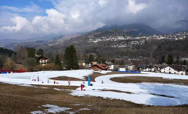 Christina Picton, of Canada, right, competes in the cross country skiing women's 10Km interval start sitting final at the 2026 Winter Paralympics, in Tesero, Italy, Wednesday, March 11, 2026. (AP Photo/Evgeniy Maloletka)