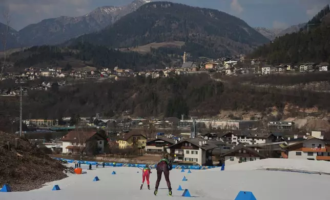 Norway's Vilde Nilsen, gold, is followed by Germany's Kathrin Marchand, 4th, in the cross country skiing women’s sprint classic standing at the 2026 Winter Paralympics, in Tesero, Italy, Tuesday, March 10, 2026. (AP Photo/Emilio Morenatti)