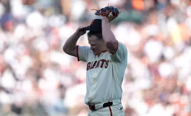 San Francisco Giants pitcher Logan Webb reacts after a two-run single hit by New York Yankees' Ryan McMahon during the second inning of a baseball game in San Francisco, Wednesday, March 25, 2026. (AP Photo/Jeff Chiu)