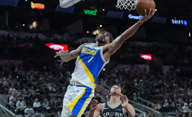 Indiana Pacers forward Obi Toppin (1) drives to the basket over San Antonio Spurs forward Carter Bryant (11) during the second half of an NBA basketball game in San Antonio, Saturday, March 21,2026. (AP Photo/Eric Gay)