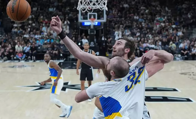 Indiana Pacers center Jay Huff (32) and San Antonio Spurs center Luke Kornet (7) battle for a rebound during the first half of an NBA basketball game in San Antonio, Saturday, March 21,2026. (AP Photo/Eric Gay)