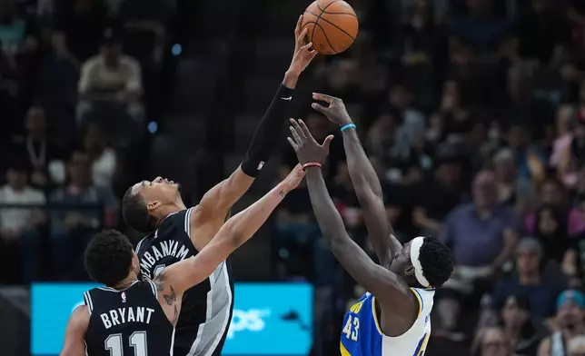 Indiana Pacers forward Pascal Siakam (43) is blocked by San Antonio Spurs forward Victor Wembanyama, center, during the first half of an NBA basketball game in San Antonio, Saturday, March 21,2026. (AP Photo/Eric Gay)