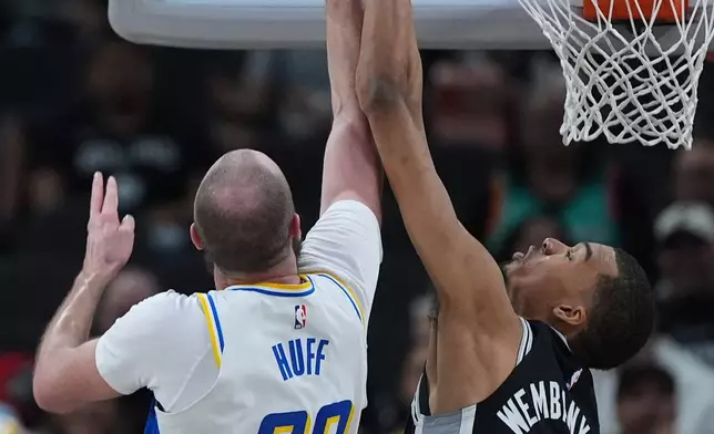 Indiana Pacers center Jay Huff (32) is blocked by San Antonio Spurs forward Victor Wembanyama (1) during the first half of an NBA basketball game in San Antonio, Saturday, March 21,2026. (AP Photo/Eric Gay)