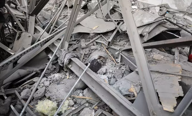 A body lies entangled in the rubble of a drug rehabilitation hospital after it was hit by a late-Monday airstrike in Kabul, Afghanistan, Tuesday, March 17, 2026. (AP Photo/Siddiqullah Alizai)