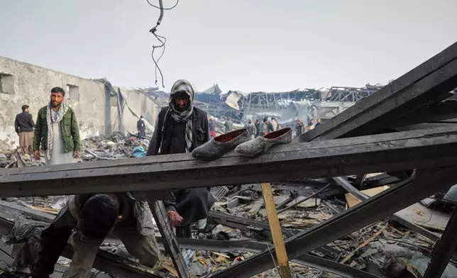 Residents and volunteers inspect the site of a late-Monday airstrike at a drug rehabilitation hospital in Kabul, Afghanistan, Tuesday, March 17, 2026. (AP Photo/Siddiqullah Alizai)