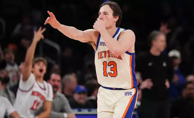 New York Knicks' Tyler Kolek (13) gestures to his team's bench after making a three-point shot during the second half of an NBA basketball game against the Washington Wizards Sunday, March 22, 2026, in New York. (AP Photo/Frank Franklin II)