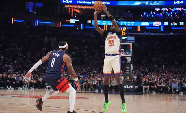 New York Knicks' Mohamed Diawara (51) shoots over Washington Wizards' Jaden Hardy (8) during the first half of an NBA basketball game Sunday, March 22, 2026, in New York. (AP Photo/Frank Franklin II)