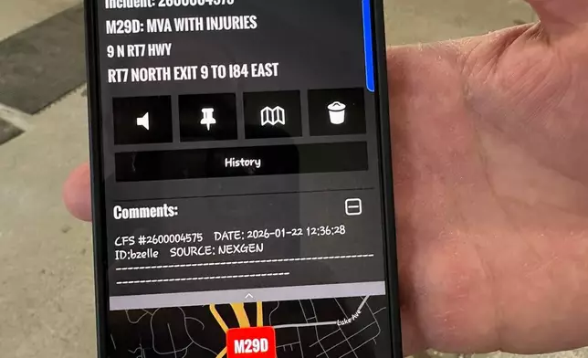 A firefighter shows how the Danbury Fire Department’s new Phoenix G2 alerting system sends information to firefighters’ phones, Sunday, Jan. 22, 2026, at the station, in Danbury, Conn. (AP Photo/Dave Collins)