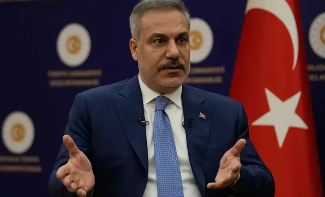 Turkey's Foreign Minister Hakan Fidan speaks during an interview with The Associated Press, in Ankara, Turkey, Saturday, March 14, 2026. (AP Photo/Khalil Hamra)