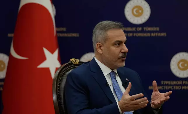 Turkey's Foreign Minister Hakan Fidan speaks during an interview with The Associated Press, in Ankara, Turkey, Saturday, March 14, 2026. (AP Photo/Khalil Hamra)