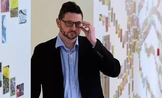 Benjamin Neale, co-director of the Stanley Center for Psychiatric Research, poses for a portrait near laboratory space at the Broad Institute, Tuesday, March 17, 2026, in Cambridge, Mass. (AP Photo/Charles Krupa)