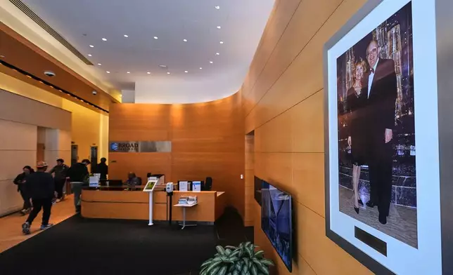 A portrait of Ted and Vada Stanley hangs in the lobby of the Broad Institute, which houses the Stanley Center for Psychiatric Research, Tuesday, March 17, 2026, in Cambridge, Mass. (AP Photo/Charles Krupa)