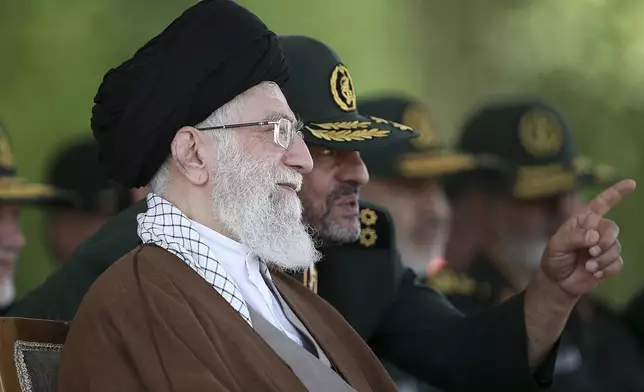 FILE- In this picture released by the official website of the office of the Iranian supreme leader, Supreme Leader Ayatollah Ali Khamenei listens to the then commander of the Revolutionary Guard Mohammad Ali Jafari during a graduation ceremony of a group of the guard's officers in Tehran, Iran, May 20, 2015. (Office of the Iranian Supreme Leader via AP, File)