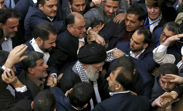 FILE - Iran's supreme leader Ayatollah Ali Khamenei, center, leaves an event titled "International Conference in Support of Palestinian Intifada," in Tehran, Iran, Feb. 21, 2017. (AP Photo/Ebrahim Noroozi, File)