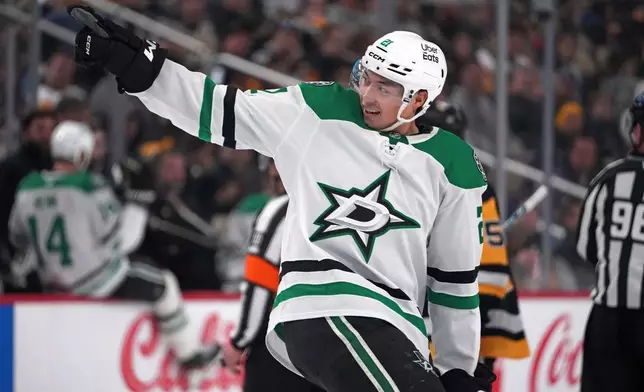 Dallas Stars' Jason Robertson (21) returns to the bench after scoring during the second period of an NHL hockey game against the Pittsburgh Penguins in Pittsburgh, Saturday, March 28, 2026. (AP Photo/Gene J. Puskar)