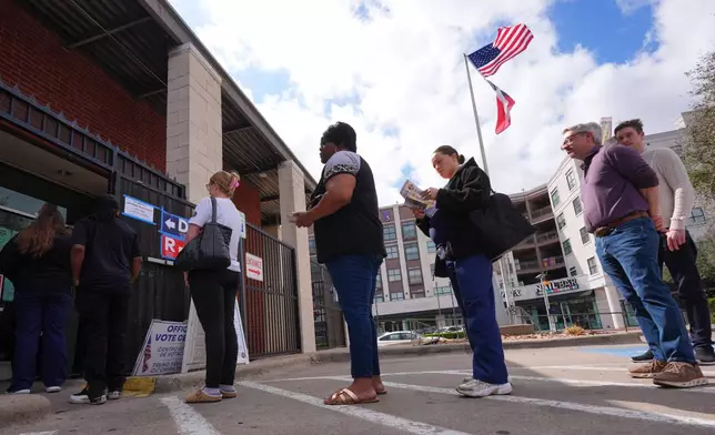 Primary voters line up to cast ballots at a voting center in Dallas, Tuesday, March 3, 2026. (AP Photo/LM Otero)