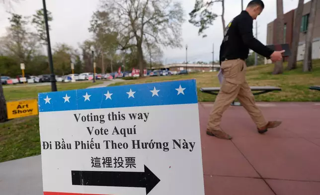 A voter makes his way into a polling location, Tuesday, March 3, 2026, in Spring, Texas. (AP Photo/David J. Phillip)