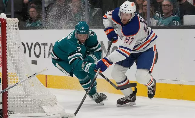 Edmonton Oilers center Connor McDavid (97) skates with the puck against San Jose Sharks defenseman John Klingberg during the second period of an NHL hockey game in San Jose, Calif., Saturday, Feb. 28, 2026. (AP Photo/Jeff Chiu)