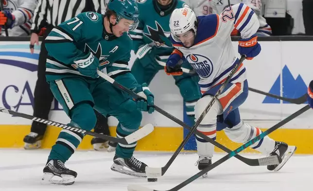 Edmonton Oilers center Matt Savoie (22) skates toward with the puck against San Jose Sharks center Macklin Celebrini (71) during the first period of an NHL hockey game in San Jose, Calif., Saturday, Feb. 28, 2026. (AP Photo/Jeff Chiu)