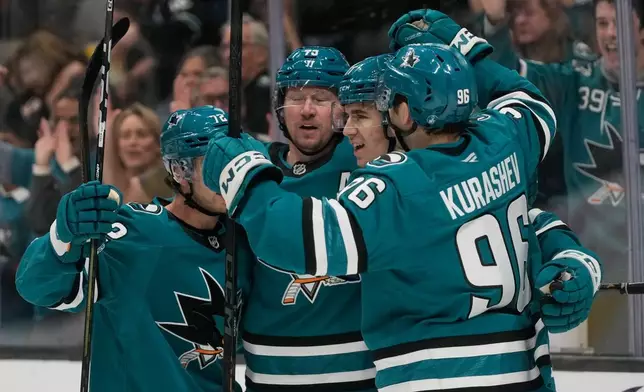 San Jose Sharks center Michael Misa, second from right, is congratulated by teammates after scoring against the Edmonton Oilers during the first period of an NHL hockey game in San Jose, Calif., Saturday, Feb. 28, 2026. (AP Photo/Jeff Chiu)